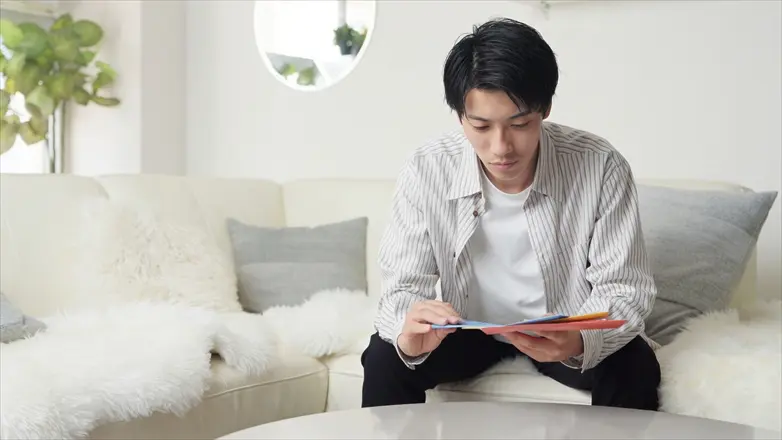 督促状を深刻な表情で見つめる男性
